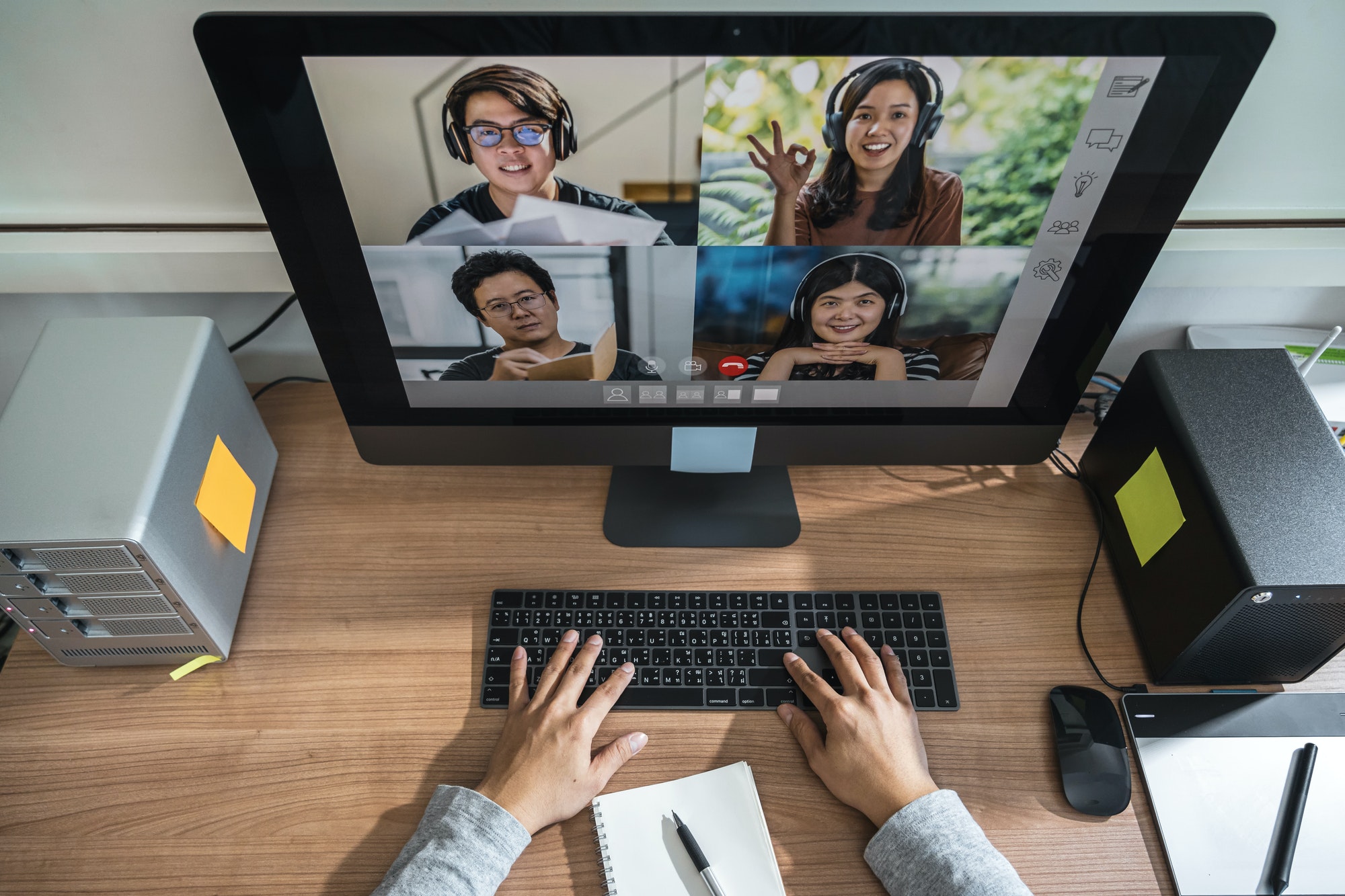 top-view-of-asian-business-man-hand-working-with-teamwork-colleague-in-video-conference.jpg